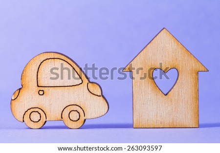 Wooden house with hole in the form of heart with car icon on purple background.