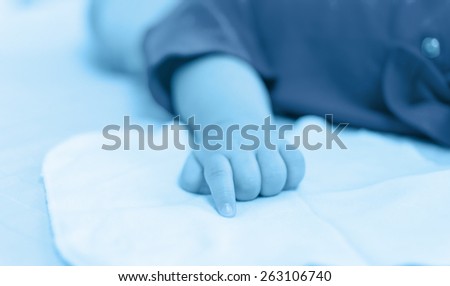 baby hand on the bed