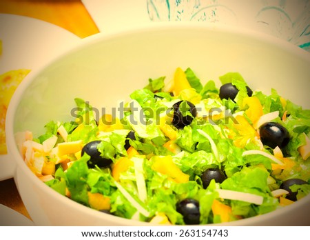 Assorted green leaf lettuce with squid and black olives. Instagram image retro style