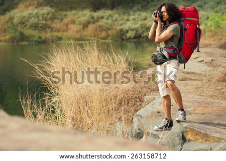 Professional nature photographer taking photographs at the lakeshore