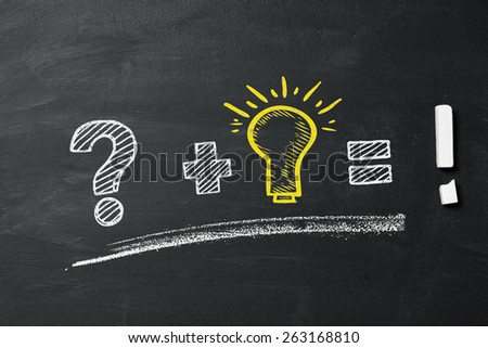 Questionmark, lightbulb and exclamation point as concept on blackboard Royalty-Free Stock Photo #263168810