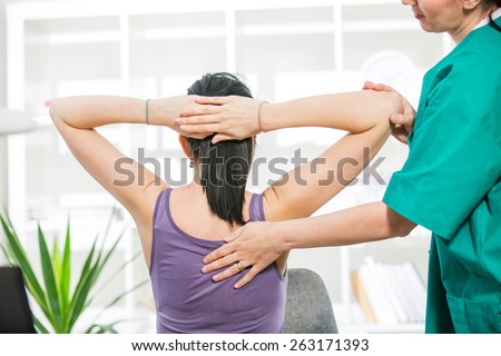 Chiropractor massage the female patient spine and back Royalty-Free Stock Photo #263171393