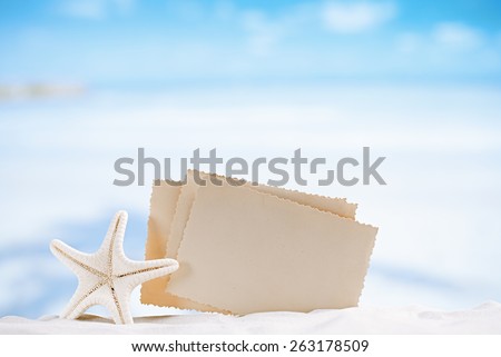 white starfish with blank retro photo on white sand beach, sky and seascape, shallow dof