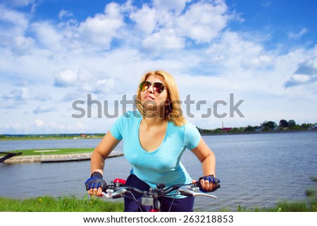 Portrait of a young woman on bicycle, outdoor shoot