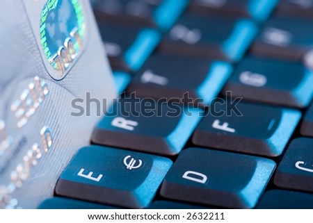 Credit Card and Keyboard. Blue light, focus on Euro-Sign.
