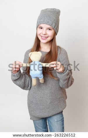 Happy little girl with teddy bear