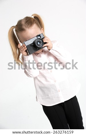 Smiling and having fun the photographer a beautiful blond girl on white background