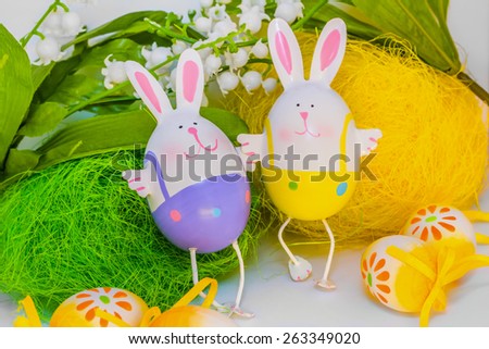 Two Easter bunnies holding hands