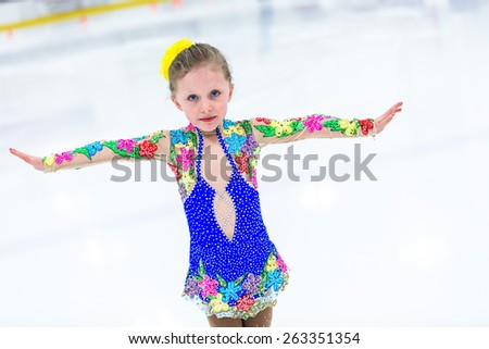 Cute girl practicing ice skating before her first competition.