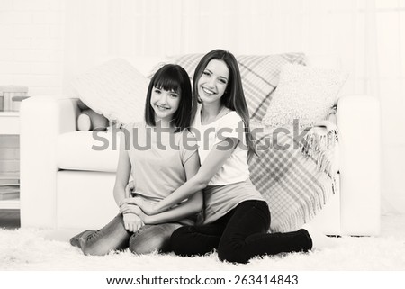 Two girls smiling on home interior background
