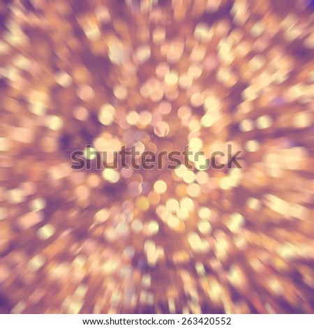 Defocused golden abstract christmas background of blurred lights with bokeh and zoom effect  in vintage style