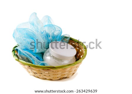 Body cream and soft bath sponge n basket, isolated on white background