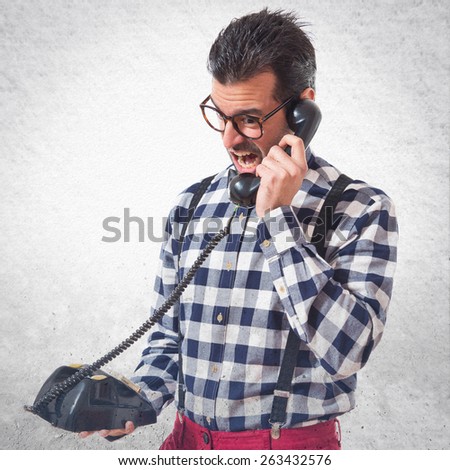Posh boy talking to vintage phone 