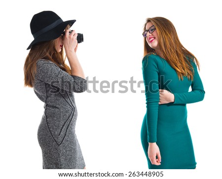 Girl photographing at her friend