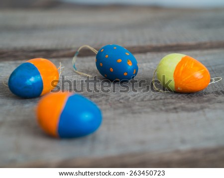 Four selfmade painted easter eggs on a wooden table - selective focus
