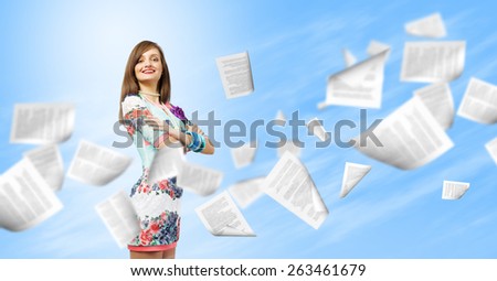 Young woman in casual and paper flying in air