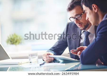 Young manager listening to his colleague explanations Royalty-Free Stock Photo #263495984