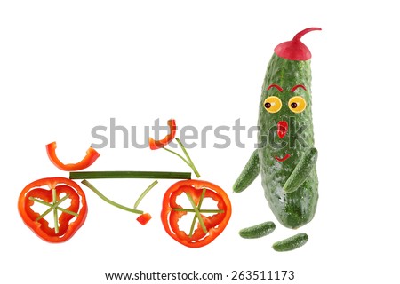 Little funny cucumber standing with bicycle. The picture is made from fruit and vegetables