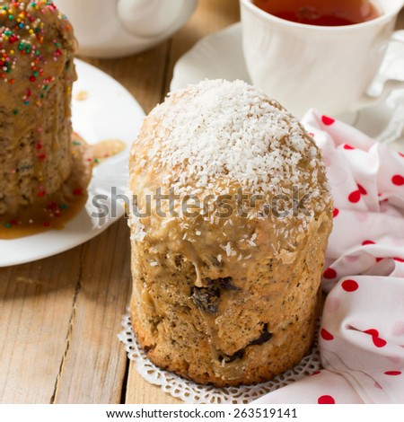Traditional Easter bread - kulich with raisins and poppy seeds decorated with coconut shavings and nonpareil balls