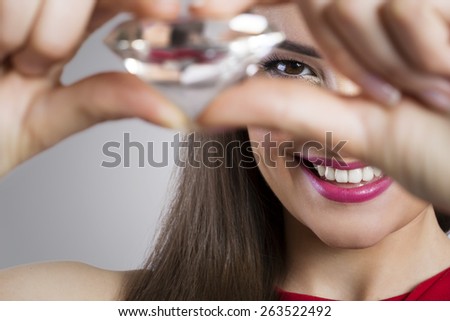 Close up of smiling woman holding diamond