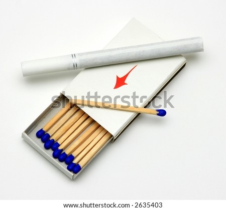 A white cigarette on top of an open box of matches