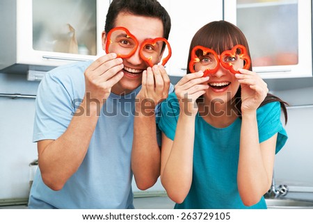 young cheerful couple cook together in the kitchen. healthy eating Royalty-Free Stock Photo #263729105