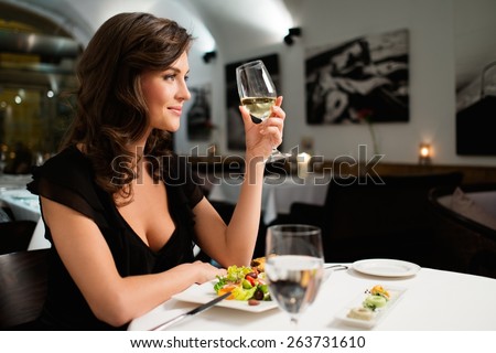 Beautiful young lady alone in restaurant  Royalty-Free Stock Photo #263731610