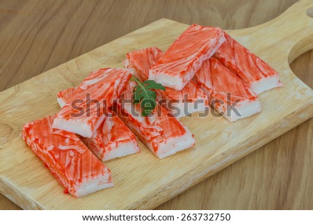 Crab sticks with ruccola leaf on the wood