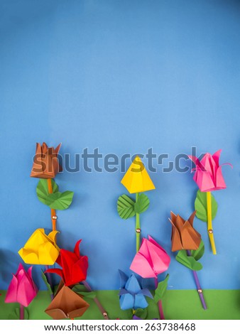 paper flowers on blue background.