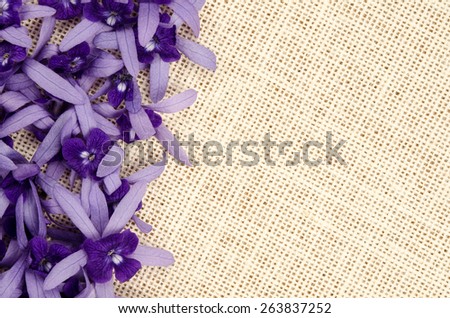 Violet flowers on sack fabric for background