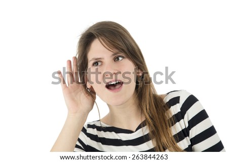 Young woman doing a hearing gesture against a white background
