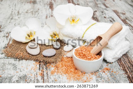 spa still life - a flowers  and towels  on a wooden background