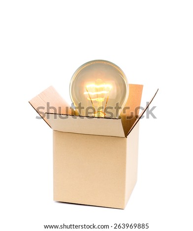 Glowing light bulb over open cardboard box