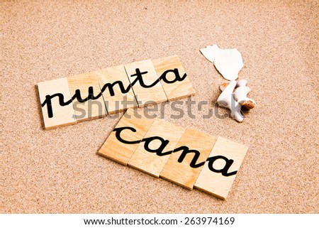 Words formed from small pieces of wood containing a sun and beach tourist destination, punta cana
