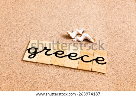 Words formed from small pieces of wood containing a sun and beach tourist destination, greece