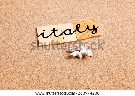 Words formed from small pieces of wood containing a sun and beach tourist destination, italy