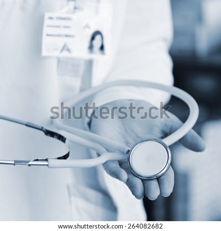 Close-up of female doctor using stethoscope , focus on stethoscope. 