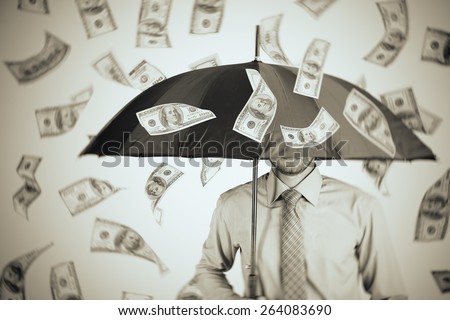 Businessman standing in the rain of money