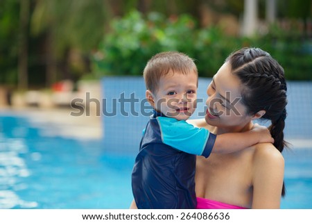 Happy Asian woman with her child at the resort