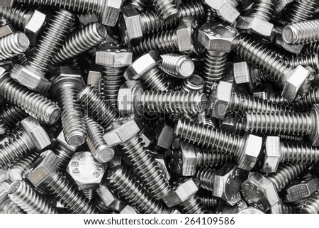 Closeup metal screw (bolt) and nuts on texture background.