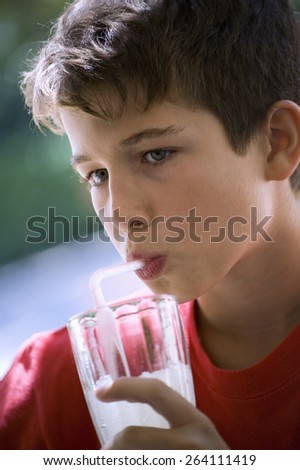 Young, twelve years old, sipping a lemonade