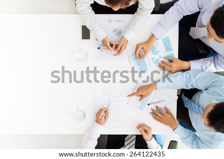 Business team analyzing financial documents Royalty-Free Stock Photo #264122435