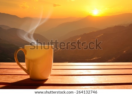 Morning cup of coffee with mountain background at sunrise Royalty-Free Stock Photo #264132746