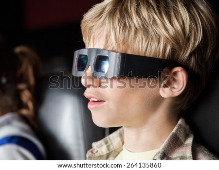 Closeup of boy watching 3D movie in cinema theater