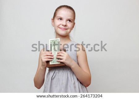 little girl with cash money dollars US