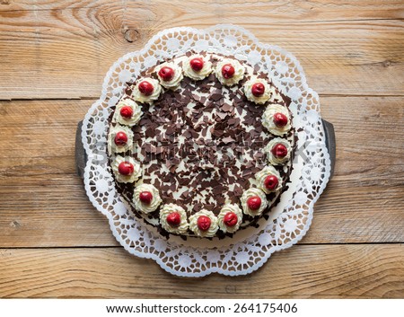 Black Forest cake on rustic wood. Royalty-Free Stock Photo #264175406