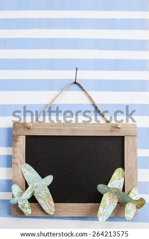 Rustic chalkboard in striped painted wooden board with paper planes