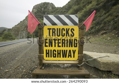 A warning sign stating Trucks Entering Highway on Route 33 near Ojai, California.