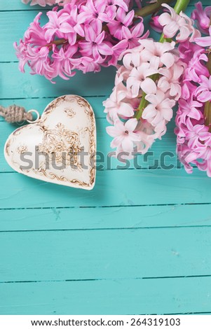Postcard with fresh hyacinths  and  heart on  wooden background. Selective focus is on flowers. Place for text.
