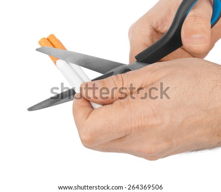 Hand with scissors and cigarettes isolated on white background